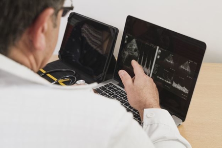 Doctor pointing at computer