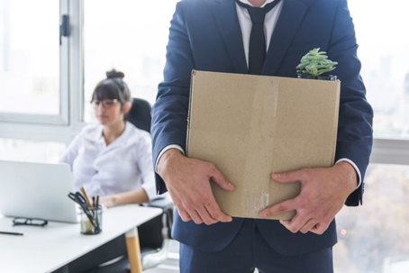 man in suit holding a box