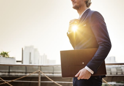 man in suit carrying a brief case