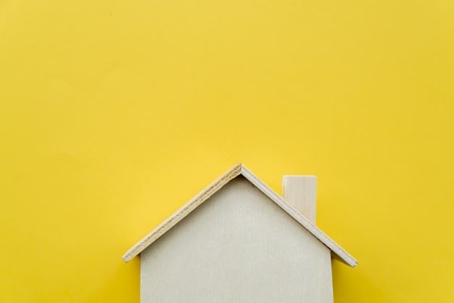 wooden house against yellow background