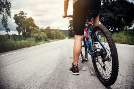 person riding bike on an empty road