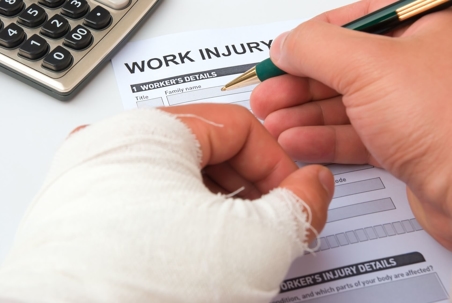 injured person filling out workers' comp