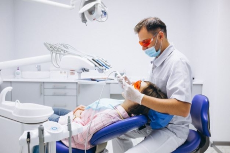 dentist fixing patients teeth